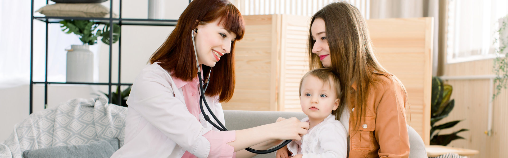 pediatrician checking little girls with stethoscope