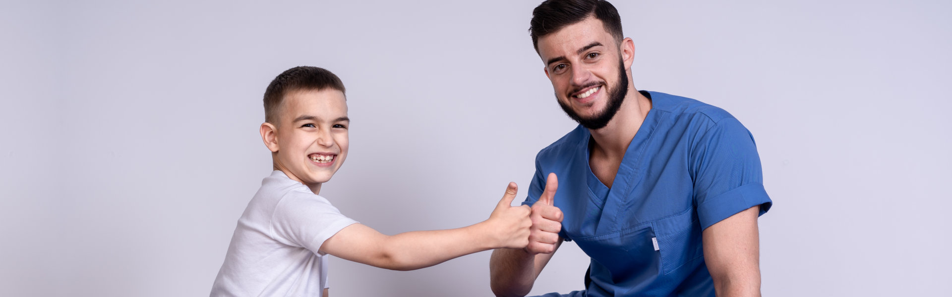 nurse and a boy doing a thumbs up