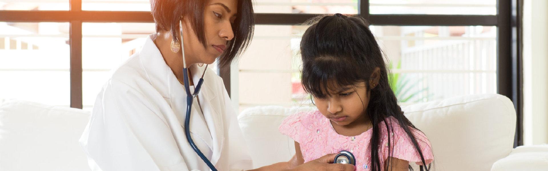 pediatrician checking the girl